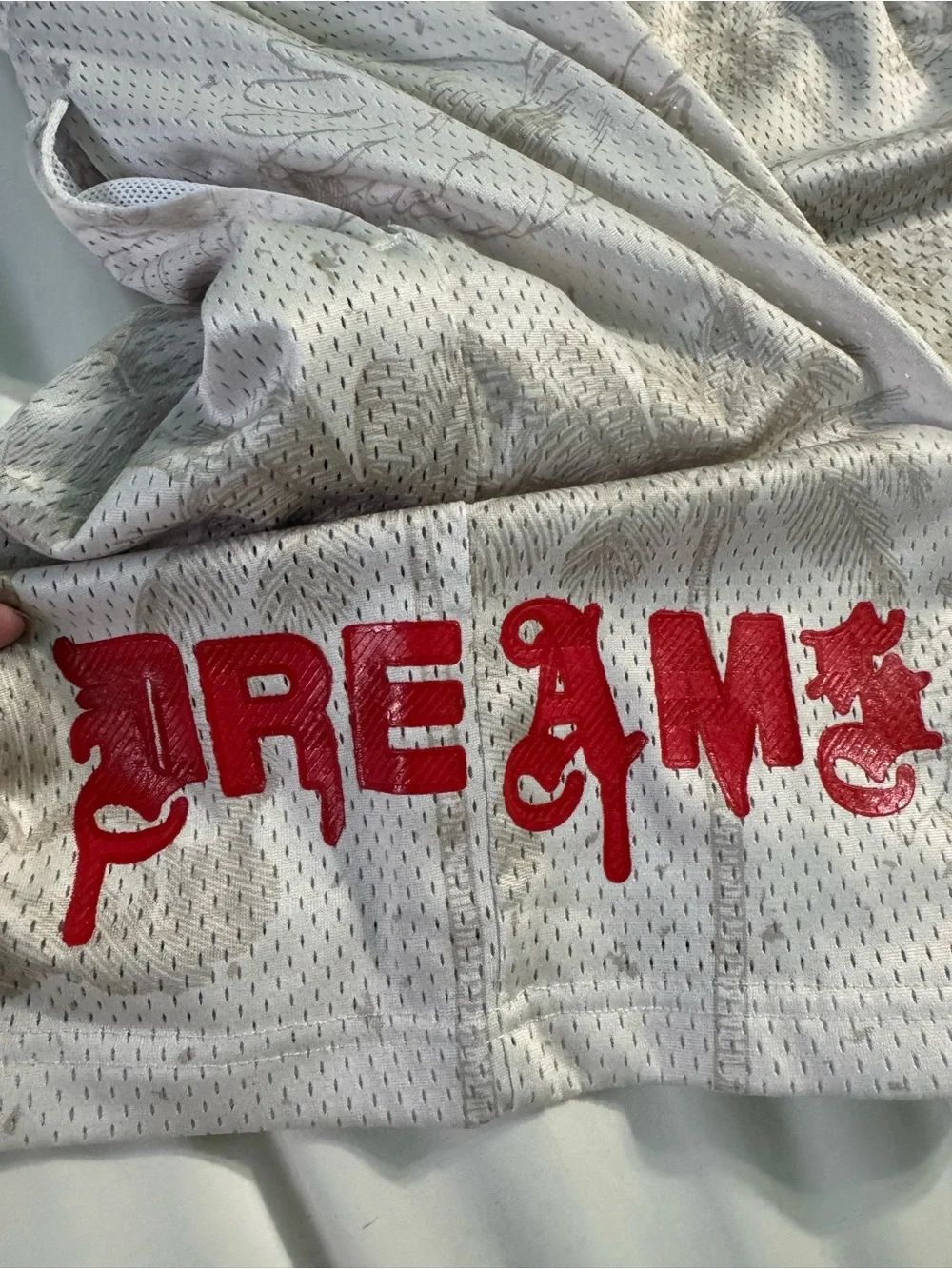 Men's White Mesh Athletic Shorts with Subtle Print and Red Accent